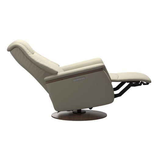 Modern light grey chair  in recliner position with padded cushions and a round dark brown wood base 